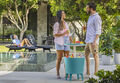 man and woman grab a drink from the cool bar next to the pool