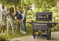 friends cheers with drinks at a party next to the patio cooler by Keter