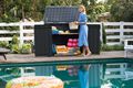 Women putting away pool accessories in her Keter Prime shed