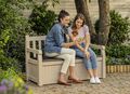 Image showing two friends looking at one mobile on a Keter  Eden Storage Bench