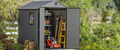 Gray storage shed in a backyard